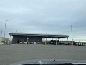 A parking lot with a building in the background.