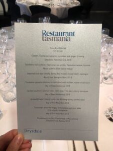 A person is holding a menu for a restaurant in Tasmania.