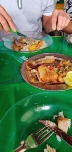 A plate of food with fish and rice on it.
