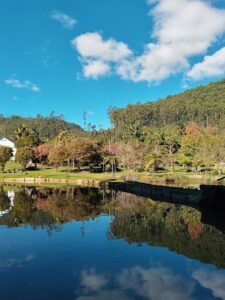 A serene scene of a lake with a reflection of a cloudy sky.