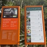 A sign for information is displayed in a park.