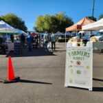 A sign welcoming visitors to the farmers market.