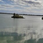 A small island in the middle of a lake.