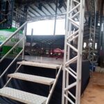 A stage with a metal staircase and a metal frame.