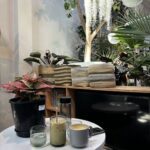 A table with a cup of coffee and a glass of juice on it.