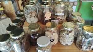 A variety of jars filled with different foods are displayed on a table.