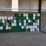 A wall of green and white barrels.