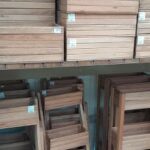 A wooden shelf with several wooden boxes on it.