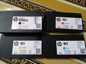 Three different colored HP ink cartridges.