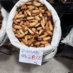 A bag of pine nuts is on display for sale.