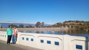 A beautiful day at the beach with a clear blue sky and calm waters.