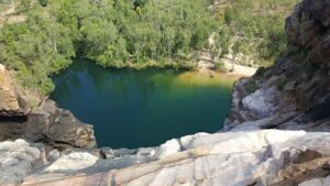 A beautiful view of a lake with a cliff overlooking it.