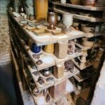 A collection of vases and pottery is displayed in a room.