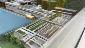 A computer generated image of a factory with a green roof.