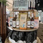 A display of various drinks and snacks, including a bottle of Prana Chai.