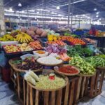 A large assortment of fruits and vegetables are displayed in a market.