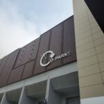A large brown building with a white sign that says "COPark".