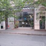 A large building with a glass front and a sign that says "Eman" on it.