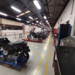 A large garage with a variety of motorcycles parked inside.