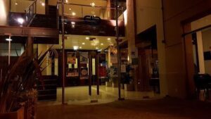 A large glass doorway with a sign on it.