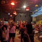 A large group of people are dancing and having a great time at a concert.