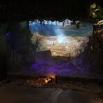 A large screen with a picture of a forest on it.