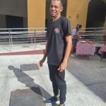 A man wearing a black shirt and black pants is standing on a metal plate.