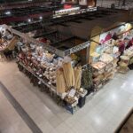 A market with a variety of foods, including a large selection of bananas.