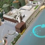 A model of a factory with a blue circle on the ground.