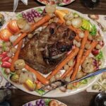 A plate of food with a carrot on it.
