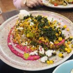 A plate of food with a pink sauce on top.