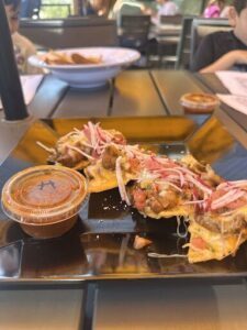 A plate of food with a side of dipping sauce.