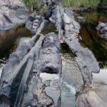 A rocky river with a waterfall.