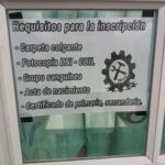 A sign is posted on a window, offering a service for inscriptions.