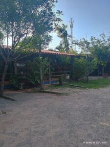 A small building with a blue roof and a wooden deck.