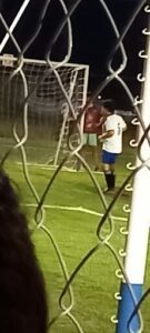 A soccer player is about to kick the ball.