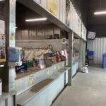 A store with a counter full of items, including a large number of books.