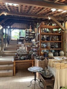 A store with a variety of pottery and vases on display.
