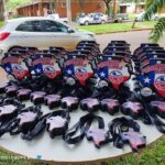 A table full of Texas souvenirs, including keychains and magnets, is displayed for sale.