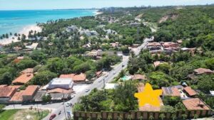 A view of a city from above, with a yellow star drawn on the roof of a building.