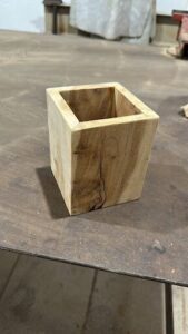 A wooden box with a crack in it sits on a table.