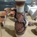 A wooden vase with a dragon design on it.