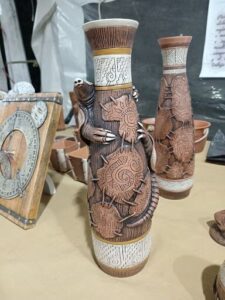 A wooden vase with a monkey on it.