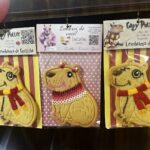 Three cookies with different designs are displayed in a row.